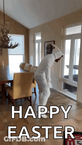 A Person In An Easter Bunny Costume Is Dancing In A Living Room With The Words Happy Easter Below Them GIF