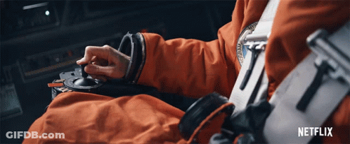 A Person In An Orange Suit Is Using A Netflix Advertisement GIF