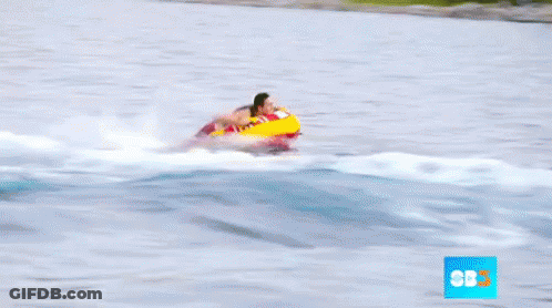 A Person Is Being Towed By A Boat With Cbs On The Bottom Right GIF