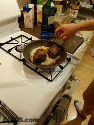 A Person Is Cooking On A Stove Next To A Box Of Don 'S GIF