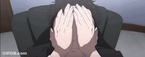 A Person Is Covering Their Face With Their Hands While Sitting In A Chair . GIF