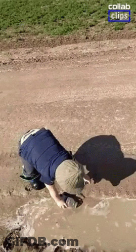 A Person Is Crawling Through A Muddy Puddle With A Collab Clips Logo In The Corner GIF