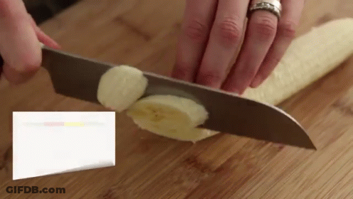 A Person Is Cutting A Banana With A Knife GIF