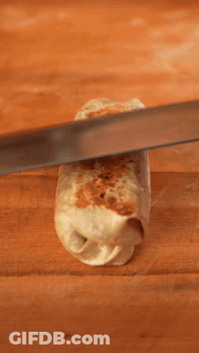 A Person Is Cutting A Burrito With A Knife That Says Han GIF