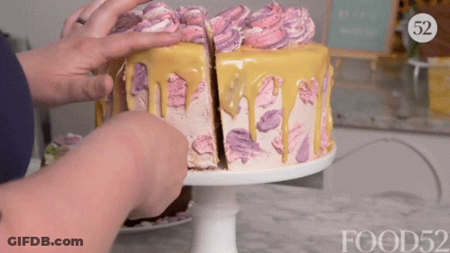 A Person Is Cutting A Cake With A Food52 Logo In The Background GIF