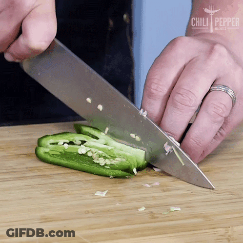 A Person Is Cutting A Jalapeno Pepper On A Wooden Cutting Board With Chili Pepper Written On The Bottom GIF