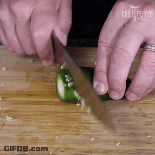 A Person Is Cutting A Jalapeno Pepper On A Wooden Cutting Board With Chili Pepper Written On The Bottom GIF