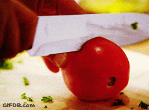 A Person Is Cutting A Tomato On A Cutting Board With A Knife That Has The Letter S On It GIF