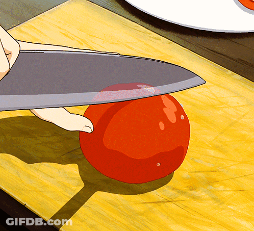 Person Cutting Tomato With Large Knife GIF