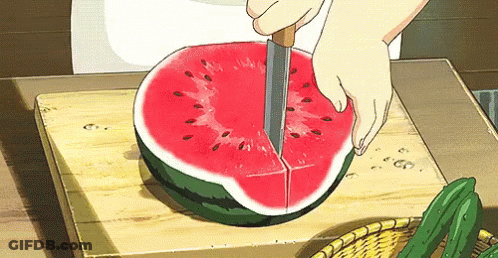 A Person Is Cutting A Watermelon On A Cutting Board . GIF