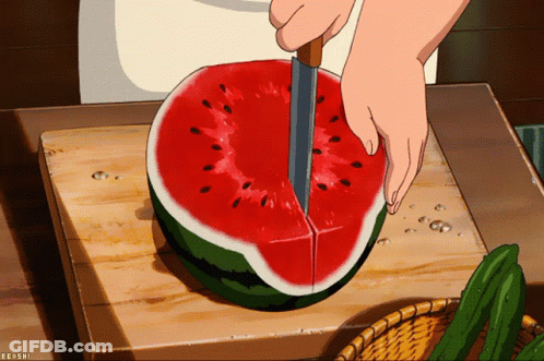 A Person Is Cutting A Watermelon On A Cutting Board With A Knife GIF