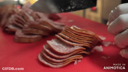 A Person Is Cutting Bacon On A Red Cutting Board With The Words Made In Animatica On The Bottom GIF