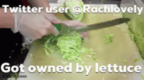 A Person Is Cutting Lettuce On A Cutting Board With A Knife . GIF