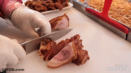 A Person Is Cutting Meat On A Cutting Board With The Words Made In Animotica In The Corner GIF