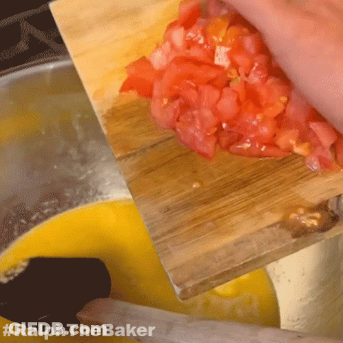 A Person Is Cutting Up Tomatoes On A Wooden Cutting Board With #Ralphthebaker Written On The Bottom GIF