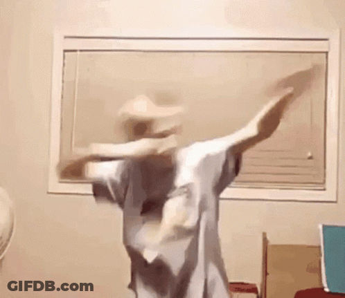 A Person Is Dancing In A Room In Front Of A Window . GIF