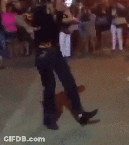A Person Is Dancing In Front Of A Crowd GIF