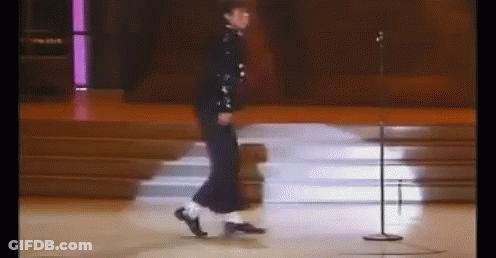 A Person Is Dancing On A Stage In Front Of A Microphone . GIF