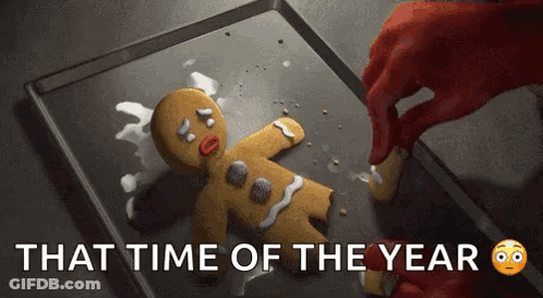 A Person Is Decorating A Gingerbread Man With Icing On A Pan . GIF