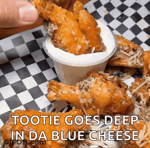 A Person Is Dipping A Chicken Wing Into A Sauce That Says " Tootie Goes Deep In Da Blue Cheese " GIF