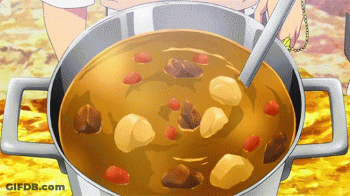 A Person Is Dipping A Spoon Into A Pot Of Soup . GIF