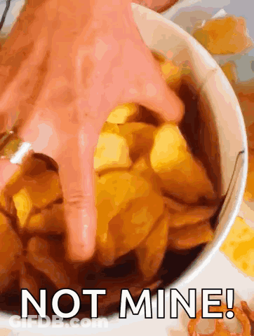 A Person Is Dipping Their Finger Into A Bowl Of Chips With The Words Not Mine Written On The Bottom GIF