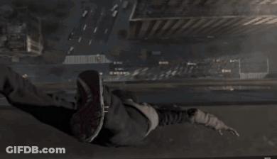 A Person Is Doing A Handstand In A Dark Area GIF