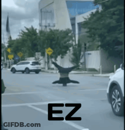 A Person Is Doing A Handstand In The Middle Of A Street With The Letters Ez Visible GIF