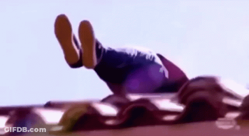 A Person Is Doing A Handstand On A Roof With Their Feet Up In The Air . GIF