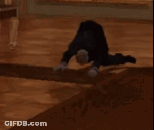 A Person Is Doing A Handstand On The Floor . GIF