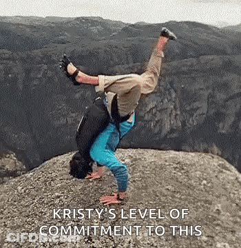 A Person Is Doing A Handstand On Top Of A Rocky Cliff . GIF