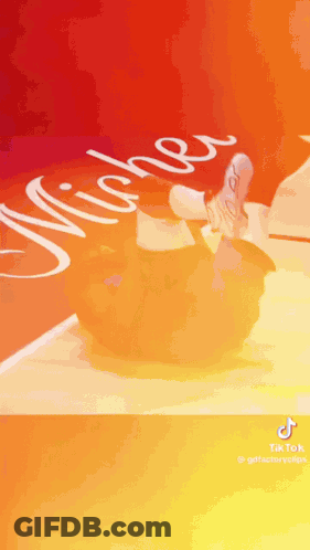 A Person Is Doing A Trick On A Basketball Court With The Word Michigan Written On It . GIF