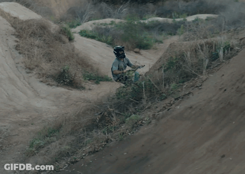 A Person Is Doing A Trick On A Bike While Wearing A Helmet With A Skull And Crossbones On It GIF