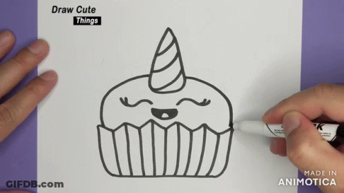 A Person Is Drawing A Cupcake With A Unicorn Horn On A Piece Of Paper GIF