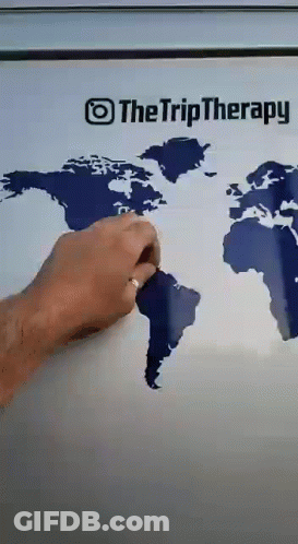A Person Is Drawing A Map Of The World On A Refrigerator Door GIF