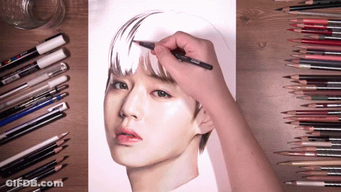 A Person Is Drawing A Woman 'S Face With Colored Pencils And Markers GIF