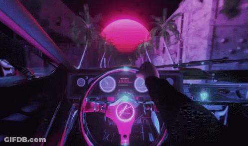 A Person Is Driving A Car With A Steering Wheel That Has A K On It GIF