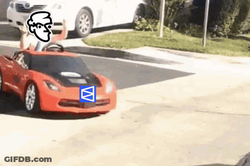 A Person Is Driving A Red Toy Car On The Street GIF