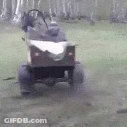 A Person Is Driving A Small Atv On A Muddy Road . GIF