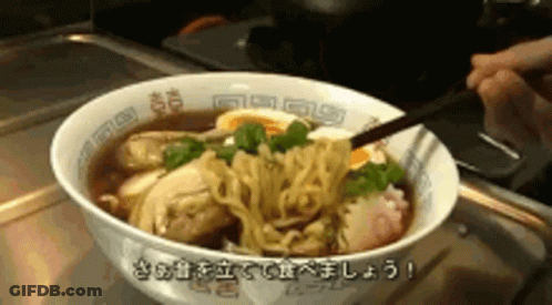A Person Is Eating A Bowl Of Ramen With Chopsticks And Eggs . GIF