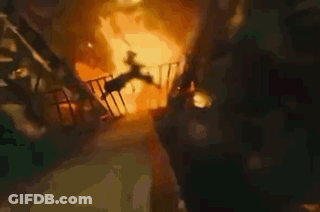 A Person Is Falling From A Balcony Into A Fire . GIF