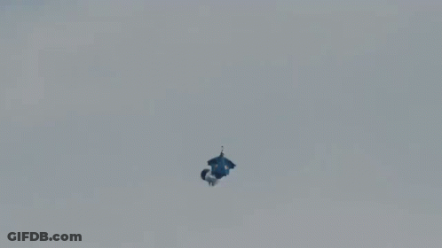 A Person Is Falling From A Parachute That Says Red Bull GIF