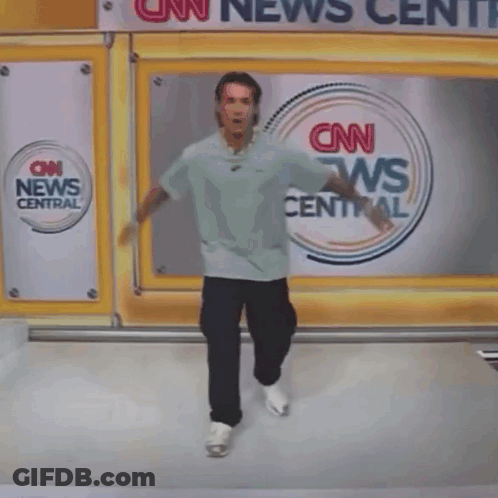 A Person Is Falling In Front Of A Cnn News Central Sign GIF