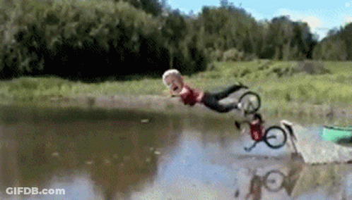A Person Is Falling Into A Lake With A Bicycle GIF
