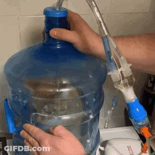 A Person Is Filling A Bottle Of Water With A Syringe That Says ' Boiling ' GIF