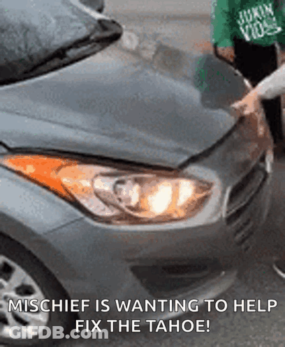 A Person Is Fixing A Car With The Caption Mischief Is Wanting To Help Fix The Tahoe . GIF