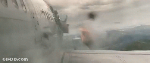 A Person Is Flying Through The Air With A Bag On Their Back . GIF