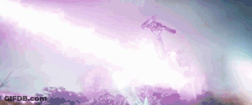 A Person Is Flying Through The Air With A Purple Lightning Bolt Coming From The Sky . GIF