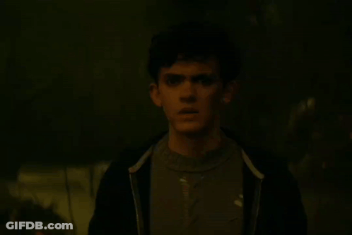 A Person Is Glowing In The Dark With A Blue Light Behind Them GIF