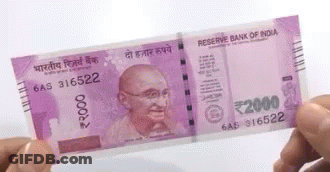 A Person Is Holding A 2000 Rupee Note In Their Hand . GIF